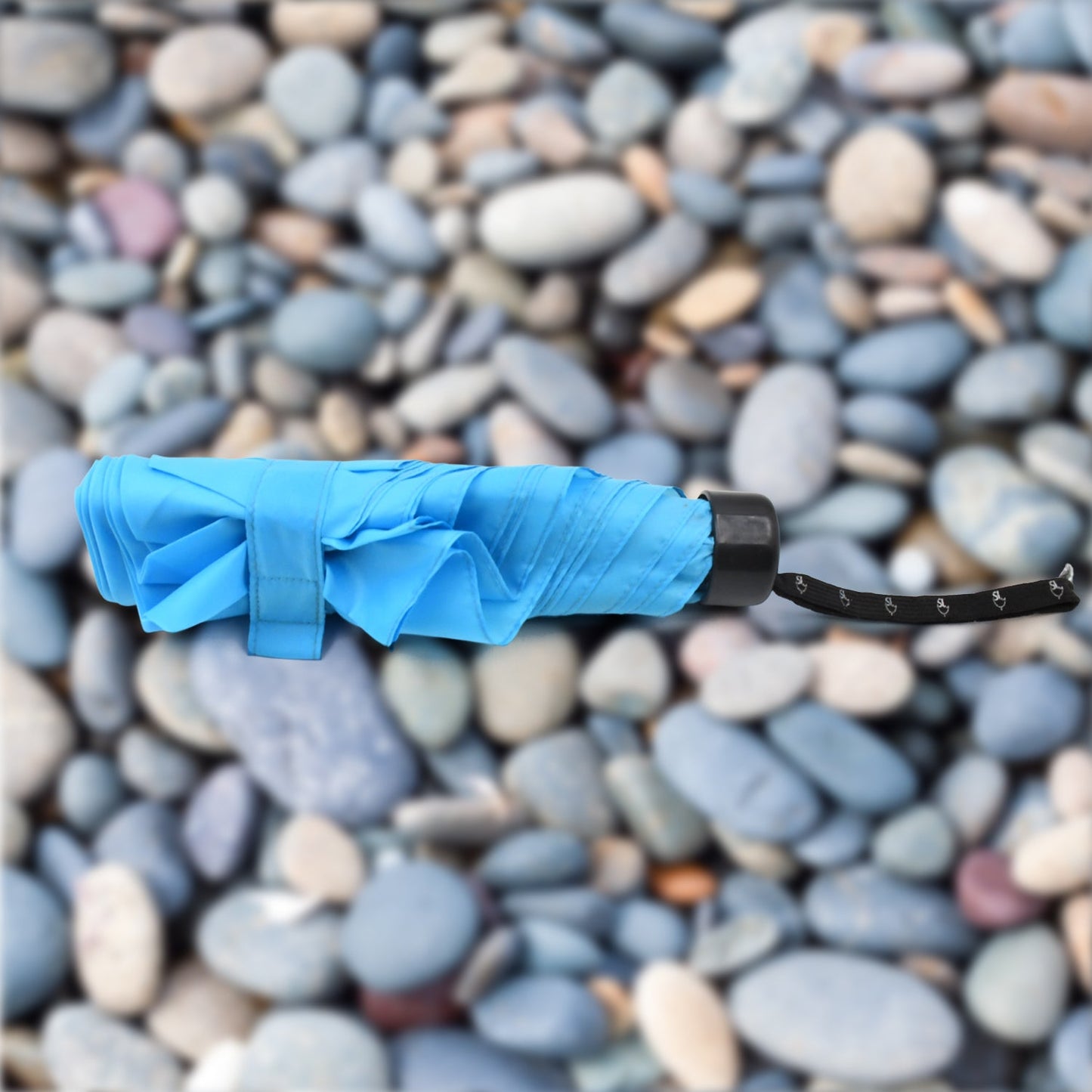 The DrizzlePro 3-fold umbrella neatly packed in its protective sleeve, ready for compact storage.