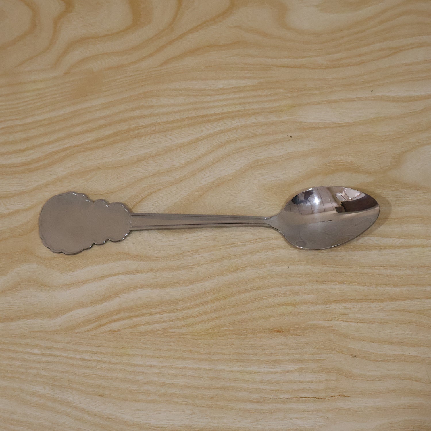 Individually packaged stainless steel carved handle dinner spoon, ideal for gifting.