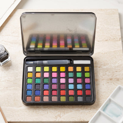 Solid watercolor paint palette in metal storage box