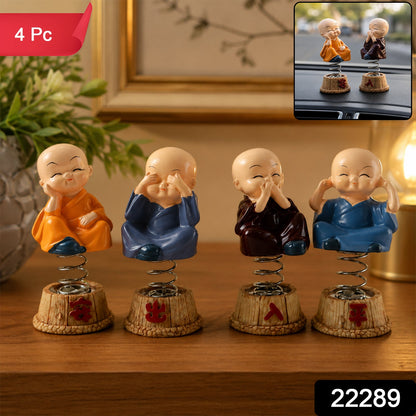 Set of four little monk statues with spring bobble heads