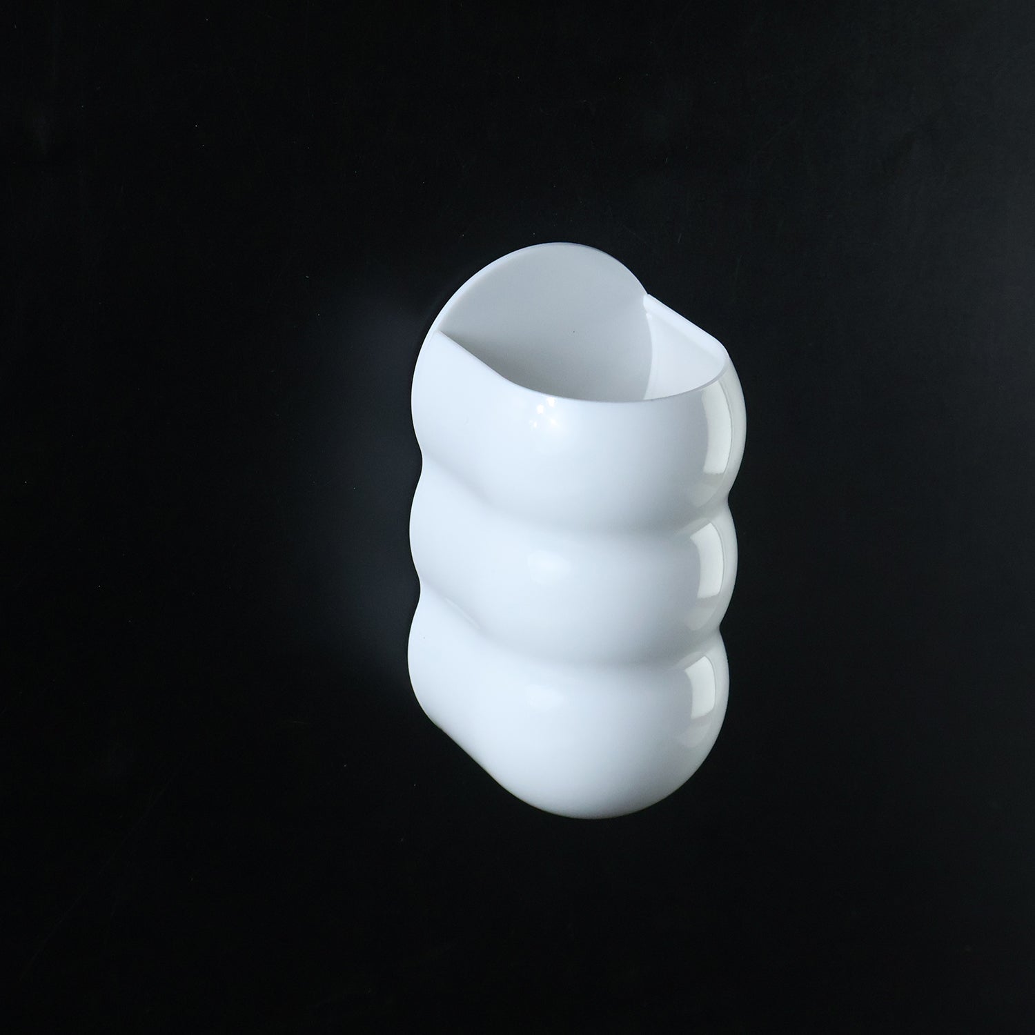 White plastic caterpillar shape wall storage holder side view