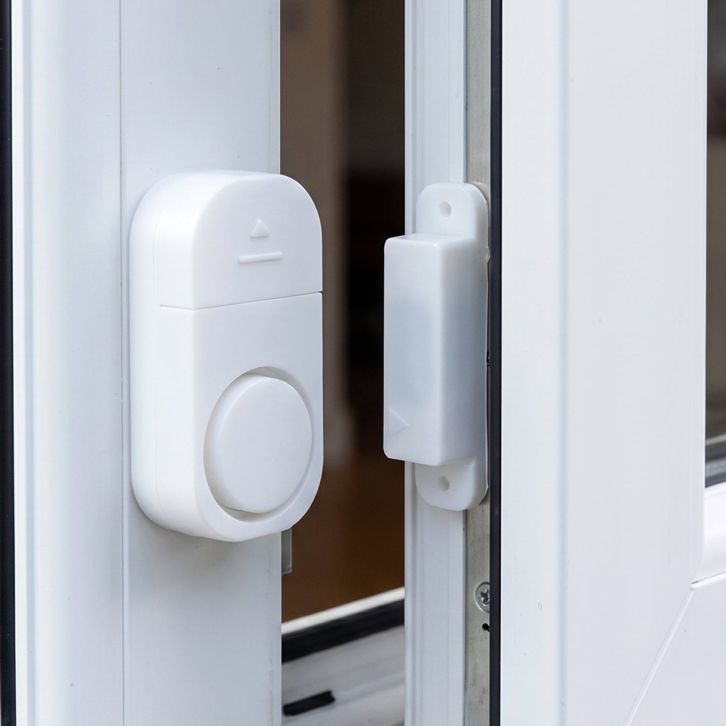 Security alarm sensor installed on a door frame