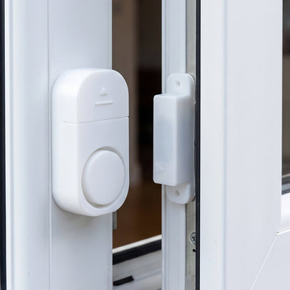 Security alarm sensor installed on a door frame
