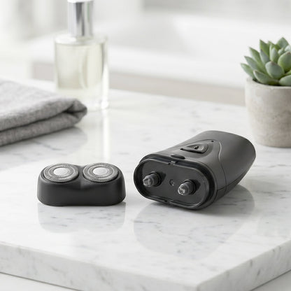 Portable electric shaver in hand showing compact size and sleek design