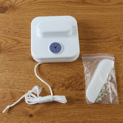 Window cleaning magnet tool with rope reaching high panes.
