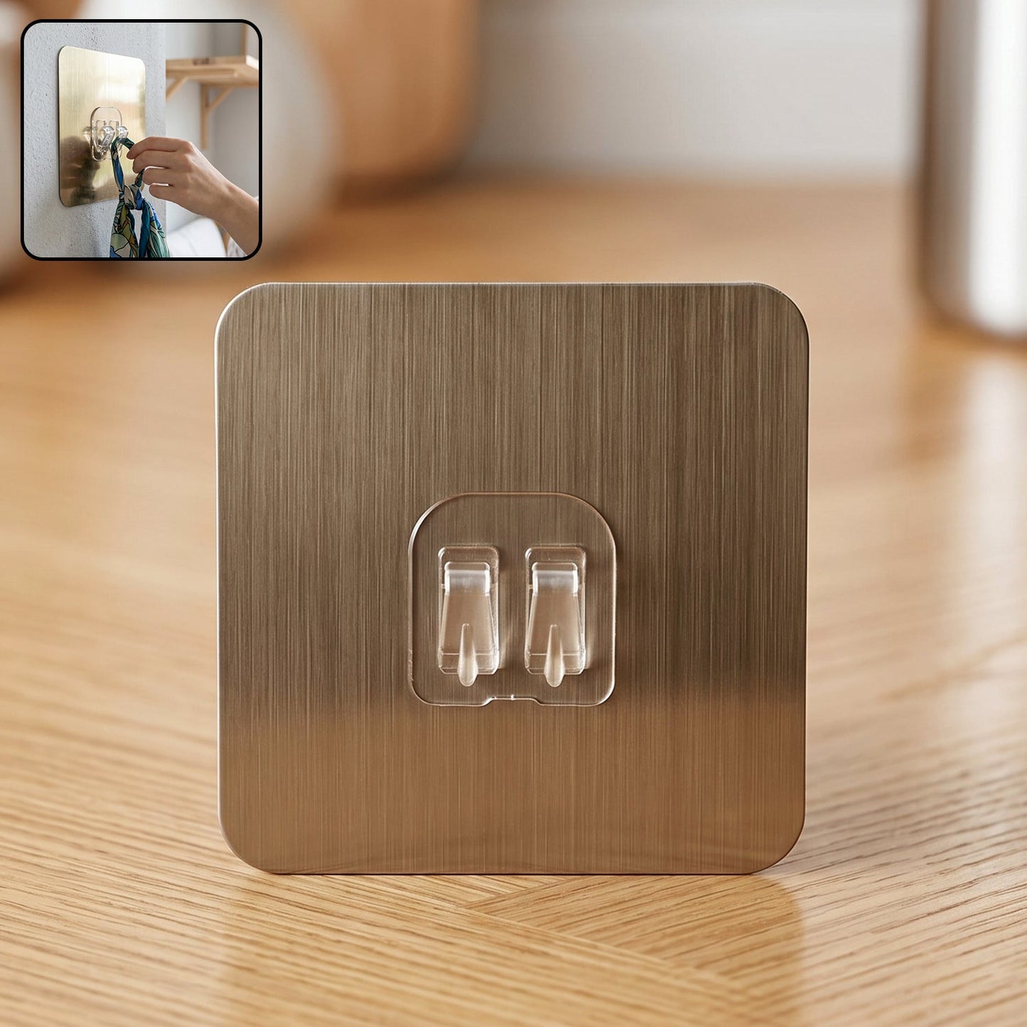 Self-adhesive wall hook with metallic finish and dual prongs for versatile hanging.